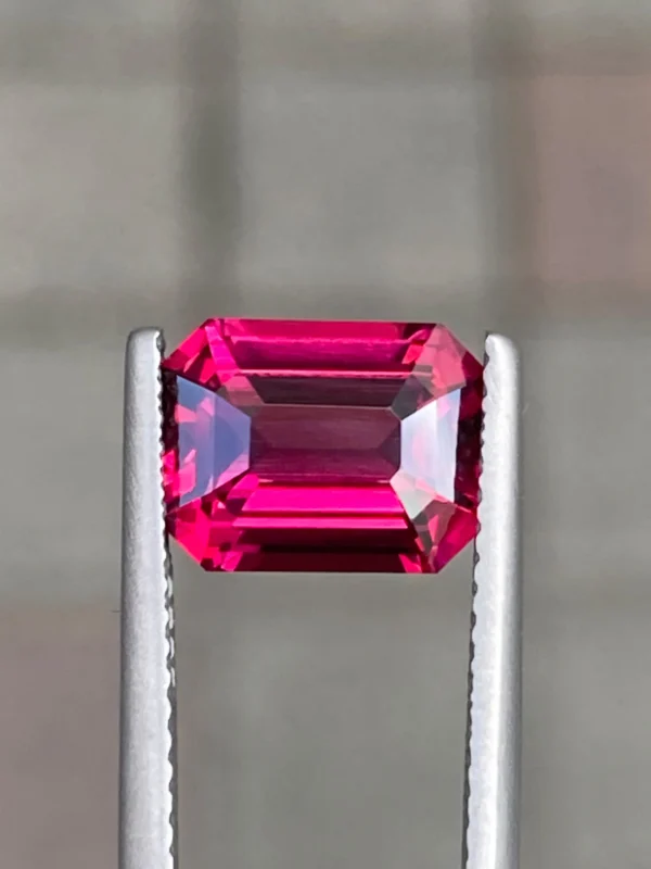 Natural rhodolite garnet emerald shape front view Natural rhodolite garnet mixed cut side view
