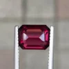 Purplish red natural rhodolite garnet under low light